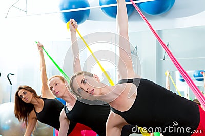 Aerobics pilates women with rubber bands in a row Stock Photo