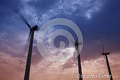 Aerogenerator windmills on dramatic sunset sky Stock Photo