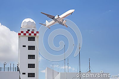 Aeronautical meteorological station tower or weather radar dome station tower in airport with passenger airplane jet taking off Stock Photo