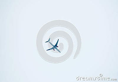 aeroplane flying on white sky background Stock Photo