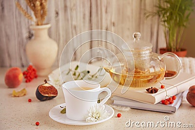 Aesthetic brunch of tea time, herbal tea and figs, peaches on the book. Sweet desserts, natural herbal tea - natural Stock Photo