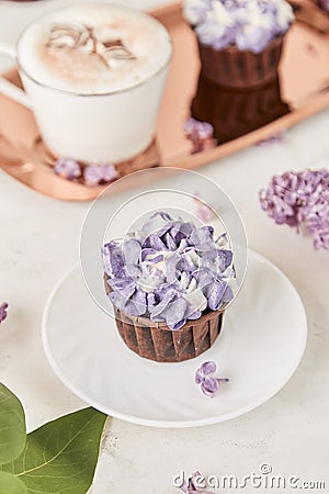 Aesthetic french purple floral cupcakes using trend Dreamy Escapism. Leisure and relax coffee time Stock Photo