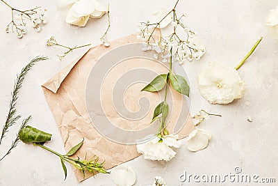 Aesthetic pastel paper backdrop - mock up, invitation, wishing, postcard, text among white eustoma, roses and gypsophila Stock Photo