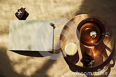 Aesthetic summer tea time, herbal tea and macarons dessert outside in the terrace under trendy hard shadows. Mock up of Stock Photo