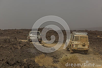 AFAR, ETHIOPIA - MARCH 25, 2019: Vehicles crossing lava fields on their way to Erta Ale volcano in Afar depression Editorial Stock Photo