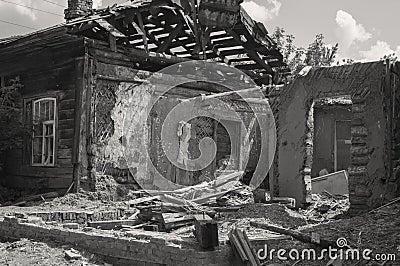 Affected as a result of a natural disaster, the building of private property.Fragment of the destroyed brick wooden house. Stock Photo