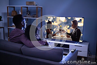 Affectionate Family Watching TV Stock Photo