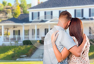 Affectionate Military Couple Looking at Beautiful New House Stock Photo