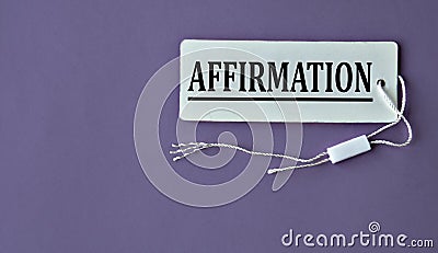 AFFIRMATION - word on white paper with thread on a purple background Stock Photo