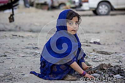 An afghan girl who collects all the rubber from workshops Editorial Stock Photo