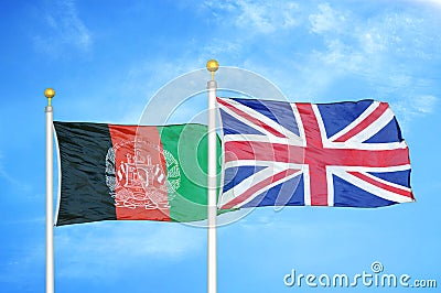 Afghanistan and United Kingdom two flags on flagpoles and blue cloudy sky Stock Photo