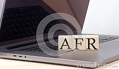 AFR word on wooden block on laptop, business concept Stock Photo