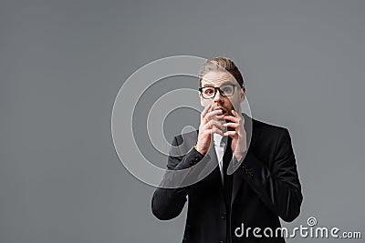 afraid businessman covering mouth with hands Stock Photo