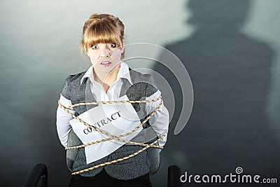 Afraid businesswoman bound by contract terms. Stock Photo