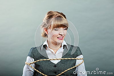 Afraid kidnapped woman tied with rope to chair. Stock Photo