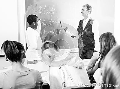 Aframerican student answers near blackboard at math lesson Stock Photo