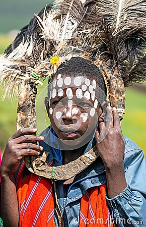 African children with ostrich feather headdress and painted of face Editorial Stock Photo