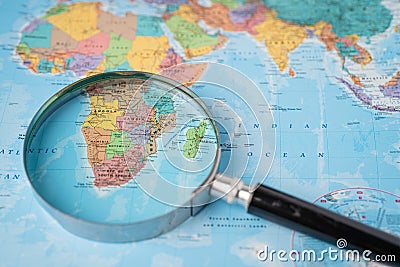 Africa, Magnifying glass close up with colorful world map Editorial Stock Photo