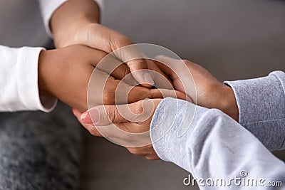 African american adult woman holding hands of child teen daughter Stock Photo