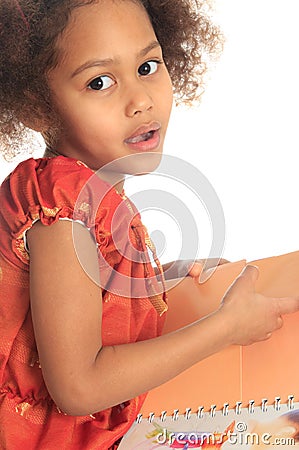 African American Asian black child reads a book Stock Photo