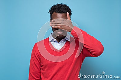 African american black man covering eyes being stressed trying to stay anonym. Stock Photo