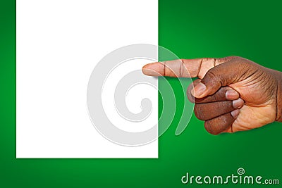 An African man's finger pointing at a blank white sign on a green background Stock Photo