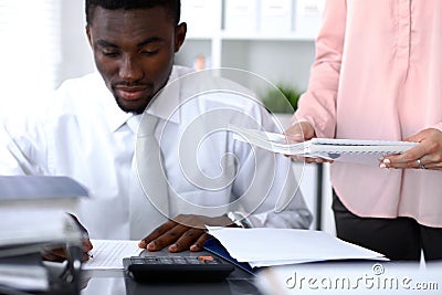 African american bookkeeper or financial inspector making report, calculating or checking balance. Internal Revenu Stock Photo