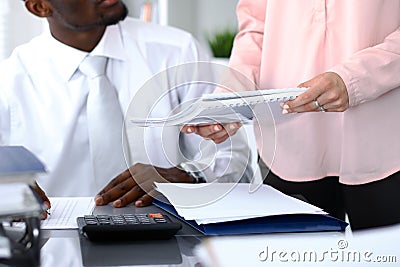 African american bookkeeper or financial inspector making report, calculating or checking balance. Internal Revenu Stock Photo