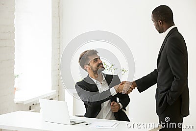 African-american boss congratulating caucasian employee with pro Stock Photo