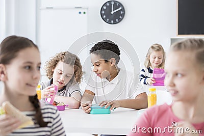 African-american boy eating lunch in the school`s canteen Stock Photo