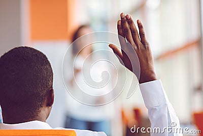 African american Business people Raising there Hand Up at a Conference to answer a question Stock Photo