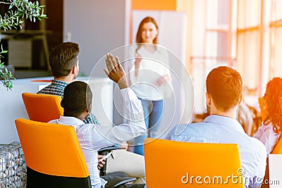 African american Business people Raising there Hand Up at a Conference to answer a question Stock Photo