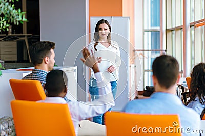 African american Business people Raising there Hand Up at a Conference to answer a question Stock Photo