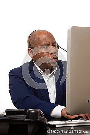 African American Businessman Looks At Computer Stock Photo