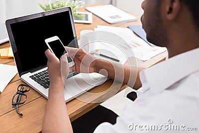 African-american businessman in office type on laptop Stock Photo