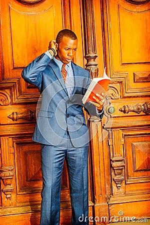 African American Businessman reading red book. Stock Photo