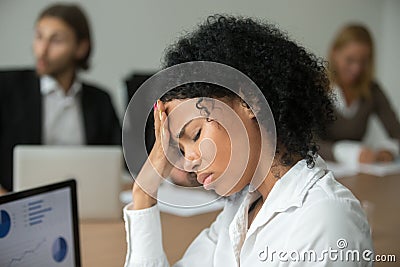 African businesswoman feeling unwell suffering from headache at Stock Photo