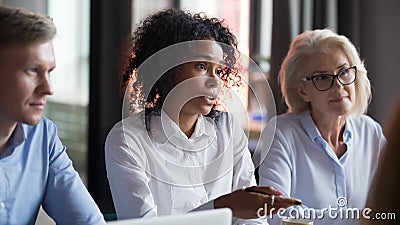 African American businesswoman talking with business partners at meeting Stock Photo