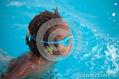 African American child with goggles in the pool Stock Photo
