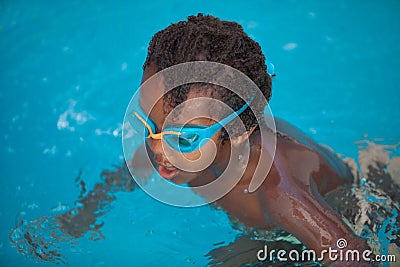 African American child with goggles in the pool Stock Photo