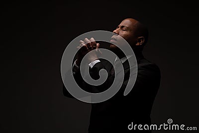 African American Christian Man Praying and Seeking Guidance from God Stock Photo