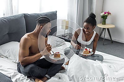 african american couple eating yummy pancakes Stock Photo