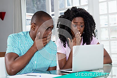 African american couple shocked about computer virus and identity theft Stock Photo