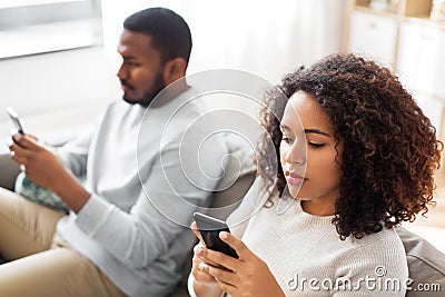African american couple with smartphone at home Stock Photo