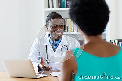 African american doctor with good news for female patient Stock Photo