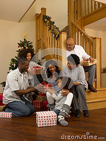 African American family exchanging Christmas gifts Stock Photo