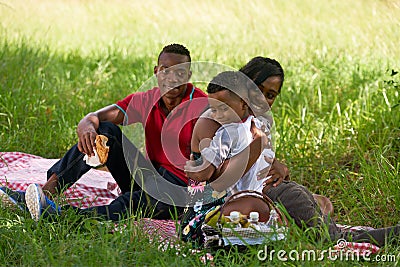 African American Family With Father Mother Child Hugging In Park Stock Photo