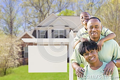 African American Family In Front of Blank Real Estate Sign and H Stock Photo