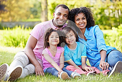 African American Family Sitting In Garden Stock Photo