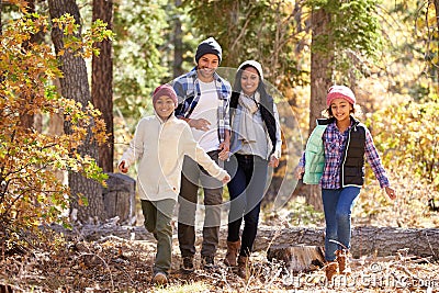 African American Family Walking Through Fall Woodland Stock Photo